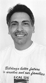 Hispanic Social Worrker with slight mustache smilling