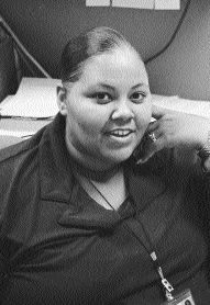 CYC youth Trinity Wallace at desk leaning on her hand