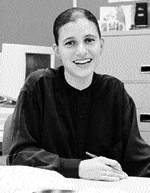Monica McCurdy smiling sitting at a desk
