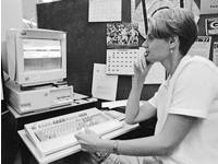 Alameda County Dependency Investigator Paula Glodowski staring at a computer
