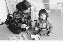 Social worker Cheng playing with a young child