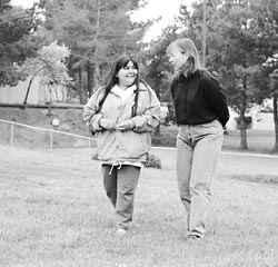 Social worker Wren Bradley walking in a park with one of her ex-clients Maria