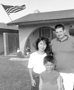 Richard Mink and his family, infront of thei suburban home.