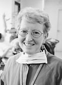 Norma Solarz with dental mast and medical  shirt