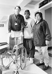 Scott Taylor standing behind a wheel chair with Luis and Josefina next to him