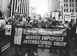 protesters with SEIU Local 535 banner marching against the war
