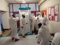 Abatement Workers in white hazard suits
