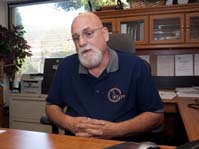 Roy Francesconi sitting at a desk explaining the program