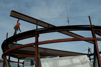 Iron Workers walking on metal beams 