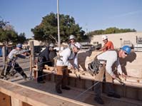 Pile Drivers erecting a plywood wall