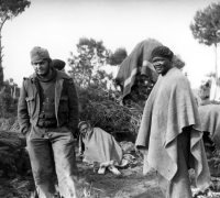 Luchelle McDaniels wearing a poncho and beret in Spain during the war